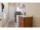 Bright laundry room with washer, dryer, and storage shelves at 6490 Everingham Ln, Sanford, FL 32771