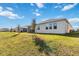 Home exterior showcasing a well-maintained lawn and lake view at 6922 Audobon Osprey Cv, Harmony, FL 34773