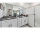 Double vanity bathroom with granite countertops and a walk-in shower at 6922 Audobon Osprey Cv, Harmony, FL 34773
