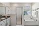 Elegant bathroom with soaking tub, shower, and granite countertop at 6922 Audobon Osprey Cv, Harmony, FL 34773