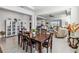 Open dining room with dark wood table and view to living room at 6922 Audobon Osprey Cv, Harmony, FL 34773
