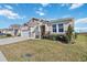 Two-story house with a two-car garage and landscaped yard at 6922 Audobon Osprey Cv, Harmony, FL 34773