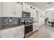 Bright kitchen with stainless steel appliances and a stylish backsplash at 6922 Audobon Osprey Cv, Harmony, FL 34773