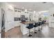 Modern kitchen featuring granite countertops, white cabinets, and a breakfast bar at 6922 Audobon Osprey Cv, Harmony, FL 34773