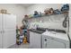 Laundry room with washer, dryer and storage shelves at 6922 Audobon Osprey Cv, Harmony, FL 34773
