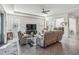 Spacious living room with taupe leather furniture and view to dining area at 6922 Audobon Osprey Cv, Harmony, FL 34773