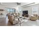 Living room with taupe leather sectional and fireplace at 6922 Audobon Osprey Cv, Harmony, FL 34773