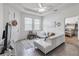 Open living room with white sectional sofa and view to bedroom at 6922 Audobon Osprey Cv, Harmony, FL 34773