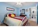 Guest bedroom with a queen bed and light blue walls at 8134 Hook Cir, Orlando, FL 32836