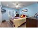 Guest bedroom with a queen bed and light blue walls at 8134 Hook Cir, Orlando, FL 32836