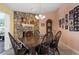 Cozy dining room features a rustic wood table and stone fireplace at 8134 Hook Cir, Orlando, FL 32836