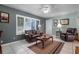 Living room with leather sofas, coffee table, and built-in bookshelves at 8134 Hook Cir, Orlando, FL 32836