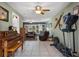 Open living space with piano, elliptical, and access to sunroom at 8134 Hook Cir, Orlando, FL 32836