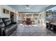 Bright sunroom features tile flooring, comfy seating, and large windows at 8134 Hook Cir, Orlando, FL 32836
