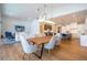 Open concept dining area with a live edge table and views into the kitchen and living room at 8679 Harbor View Dr, Orlando, FL 32817