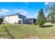 Large backyard with solar panels and screened-in pool area at 8729 Eden Cove Dr, Winter Garden, FL 34787