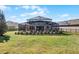 Large backyard with grassy area and screened pool enclosure at 8729 Eden Cove Dr, Winter Garden, FL 34787
