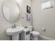 Small bathroom with pedestal sink and toilet at 8729 Eden Cove Dr, Winter Garden, FL 34787