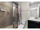 Bathroom with shower, toilet and dark vanity with a single sink at 8729 Eden Cove Dr, Winter Garden, FL 34787
