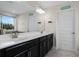 Double vanity bathroom with large mirror, walk-in shower, and view of backyard at 8729 Eden Cove Dr, Winter Garden, FL 34787
