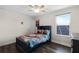 Bedroom with twin-size bed, ceiling fan, and window overlooking solar panels at 8729 Eden Cove Dr, Winter Garden, FL 34787