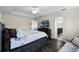 Main bedroom with king-size bed, ensuite bathroom access, and dark-grey wood-look flooring at 8729 Eden Cove Dr, Winter Garden, FL 34787