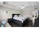 Spacious bedroom with dark-grey platform bed, ceiling fan, and dark-grey wood-look flooring at 8729 Eden Cove Dr, Winter Garden, FL 34787
