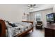 Bedroom with full-size bed, ceiling fan, and a relaxing recliner at 8729 Eden Cove Dr, Winter Garden, FL 34787
