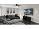 Large bonus room with L-shaped sectional sofa and flat screen TV at 8729 Eden Cove Dr, Winter Garden, FL 34787