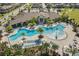 Overhead view of the resort-style pool with lounge chairs, palm trees, and the community center at 8729 Eden Cove Dr, Winter Garden, FL 34787