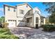 Two-story house with beige walls and paver driveway at 8729 Eden Cove Dr, Winter Garden, FL 34787