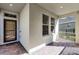 Front entry with covered porch and brick pavers at 8729 Eden Cove Dr, Winter Garden, FL 34787