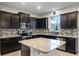 Spacious kitchen with dark cabinetry, granite counters, and stainless steel appliances at 8729 Eden Cove Dr, Winter Garden, FL 34787