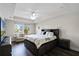 Main bedroom with king-size bed, TV, and plenty of natural light at 8729 Eden Cove Dr, Winter Garden, FL 34787