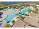 Aerial view of a large community pool featuring palm trees, lounge chairs, and a splash pad at 8729 Eden Cove Dr, Winter Garden, FL 34787