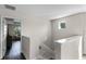 Upstairs hallway with a view into a bedroom and a staircase at 8729 Eden Cove Dr, Winter Garden, FL 34787