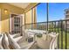 Screened balcony with outdoor furniture and view of green space at 8774 Worldquest Blvd, Orlando, FL 32821