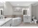 Modern bathroom with double vanity, soaking tub and toilet at 8774 Worldquest Blvd, Orlando, FL 32821
