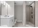 Bathroom with walk-in shower, white vanity, and marble countertop at 8774 Worldquest Blvd, Orlando, FL 32821