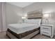 Cozy bedroom with double bed, nightstands, and wall art at 8774 Worldquest Blvd, Orlando, FL 32821