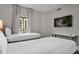 Bedroom with two twin beds and mounted TV at 8774 Worldquest Blvd, Orlando, FL 32821