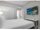 Bedroom with a queen bed and mounted TV at 8774 Worldquest Blvd, Orlando, FL 32821