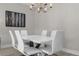 Bright dining room with white table and chairs, and modern chandelier at 8774 Worldquest Blvd, Orlando, FL 32821