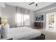 Main bedroom with king bed, TV, and access to private balcony at 8774 Worldquest Blvd, Orlando, FL 32821