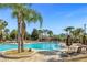 Relaxing resort-style pool with lounge chairs and palm trees at 8801 Worldquest Blvd, Orlando, FL 32821