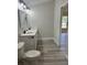 Bathroom featuring double vanity with quartz countertops and luxury vinyl floors at 102 Colomba Rd, Debary, FL 32713