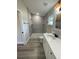 Bathroom with gray tile shower and white vanity at 102 Colomba Rd, Debary, FL 32713