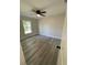 Well-lit bedroom, ceiling fan, and grey vinyl plank flooring at 102 Colomba Rd, Debary, FL 32713