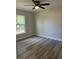 Bedroom with gray laminate flooring, a modern ceiling fan, and a window at 102 Colomba Rd, Debary, FL 32713