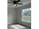 Bedroom with gray laminate flooring, a ceiling fan, and a bright window at 102 Colomba Rd, Debary, FL 32713